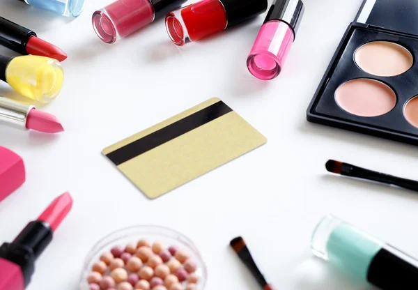 Cosmetics discount or gift card with makeup set on white backround