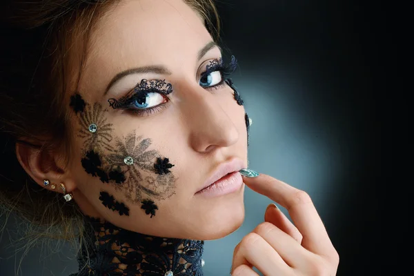 Woman black lace flowers on face