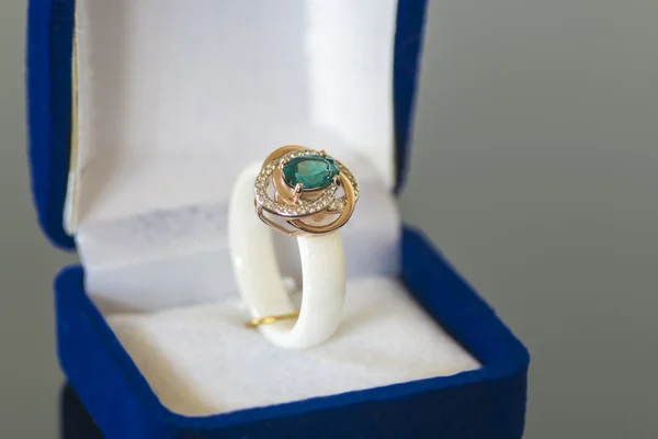 Ring with a blue stone in box