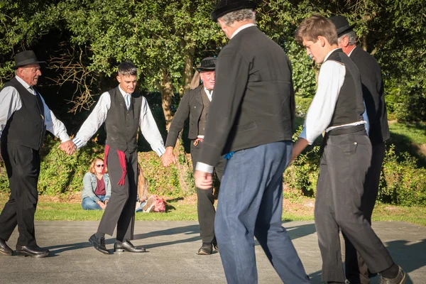 Men dance round in a show