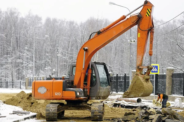 MOSCOW RUSSIA - 28 Nowember 2015 - Excavator works on the piping systems for hot and cold wate
