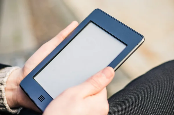 Close-up Of Man Holding Touch Screen Device Showing An E-book