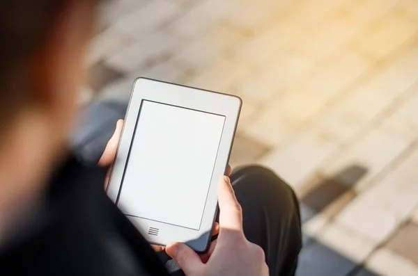 Close-up Of Man Holding Touch Screen Device Showing An E-book