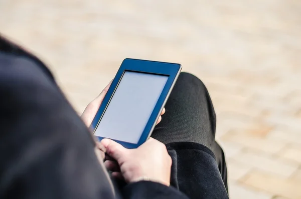 Close-up Of Man Holding Touch Screen Device Showing An E-book