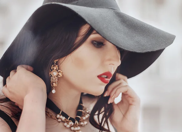 Portrait of a beautiful girl in a black hat, Italian-style