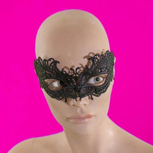 Portrait of mannequin female with black mask isolated on purple