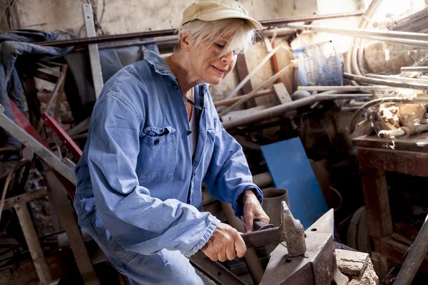 Beautiful lady at work in his old workshop