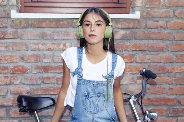 Young beautiful woman enjoys music with headphones