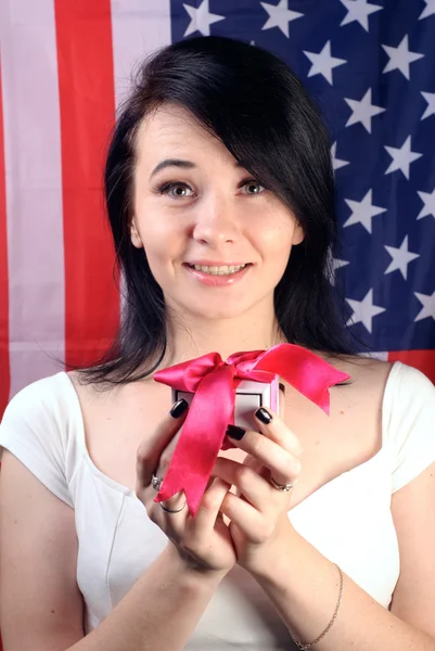 Young attractive woman with gift in hand,