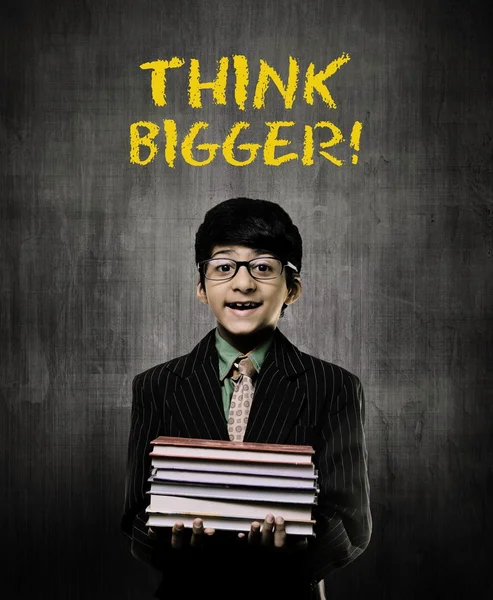 Think Big. Genius Little Boy Holding Books Wearing Glasses