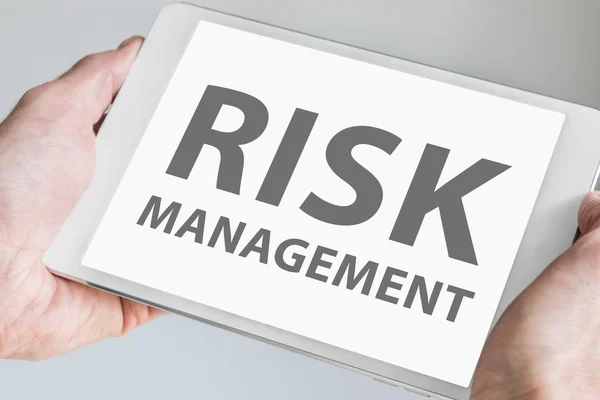 Digital risk Management texted displayed on touchscreen of modern tablet or smart device.