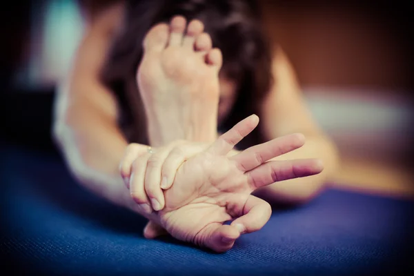 Young Female Yogi in Janu Sirsasana Head To Knee Forward Bend Po