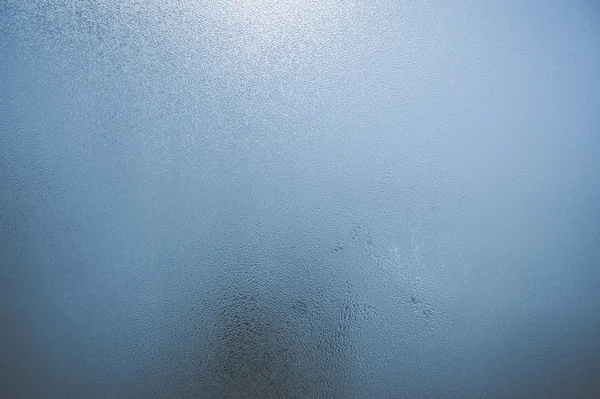 Closeup on fog condensation on window glass