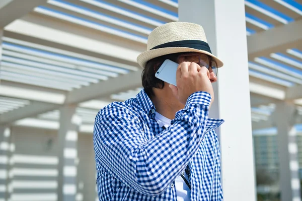 Side view shot of person holding using smartphone on terrace background outdoors