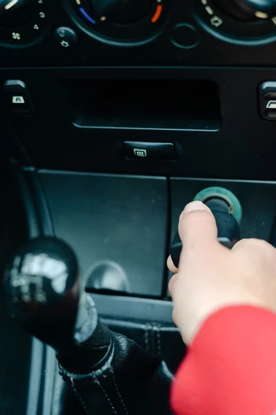 Hand of female and car phone charger, Closeup