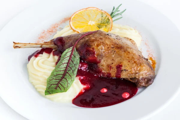 Duck with mashed potato and cranberry sauce