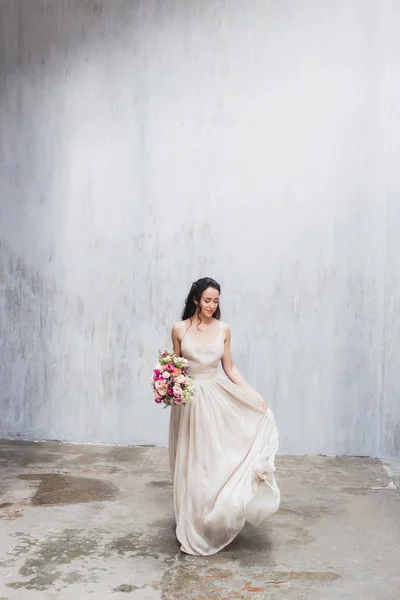 Bride in silk dress with flowers