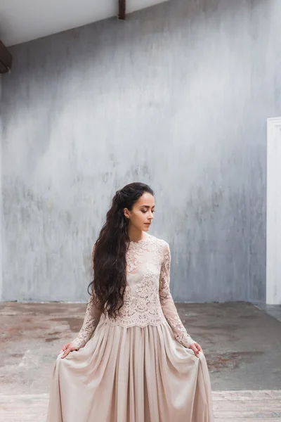 Woman in a silk dress with lace cape