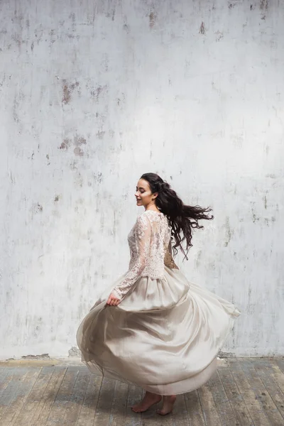 Woman in a silk dress with lace cape