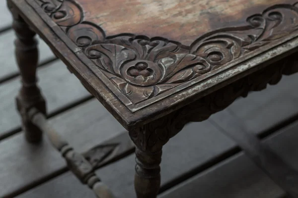 Old vintage wood dark table balinese style. Wood carving