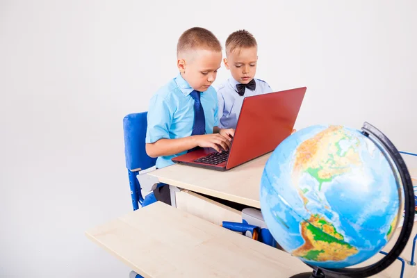 Two boys sitting at the computer school