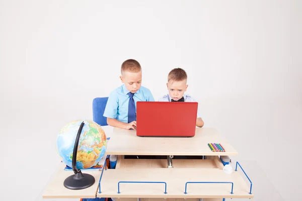 Two boys sitting at the computer school