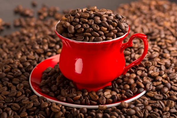 Cup of coffee beans on coffee beans background. smoke
