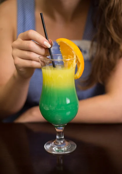 Girl drinking cocktail in casino