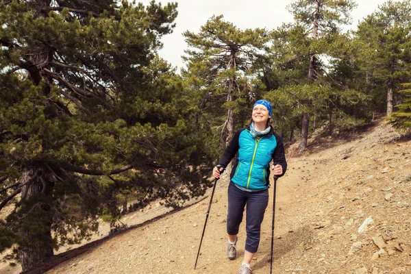 Happy woman, hiker goes on trail