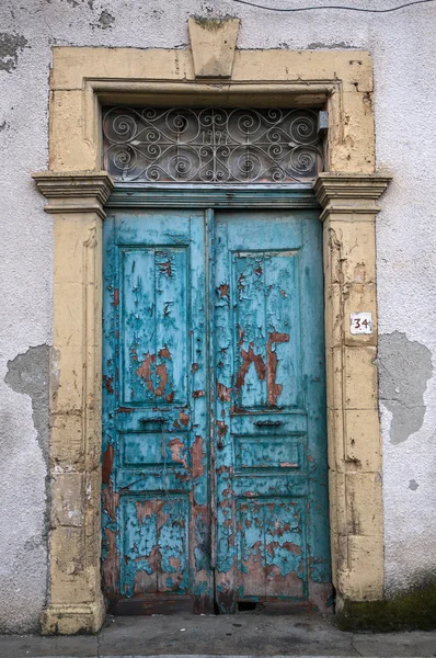 Old dilapidated blue wooden door