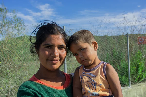 Serbia October 2015: A young Syrian woman holding a child on the border with the European Union