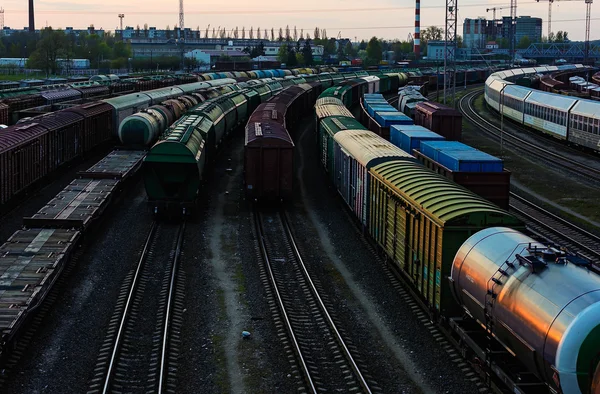 Cargo train platform at sunset with containers with various goods