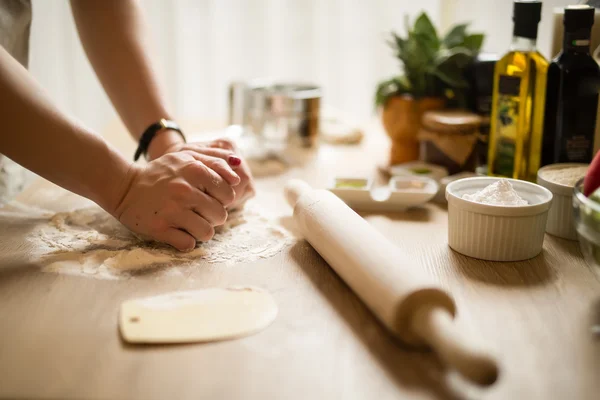 Woman cooking healthy balanced food.Carbohydrates.Whole grains.Dieting Concept.Healthy Lifestyle.Cooking food at home.Woman preparing dough for homemade puffed pastry on wooden table in the kitchen