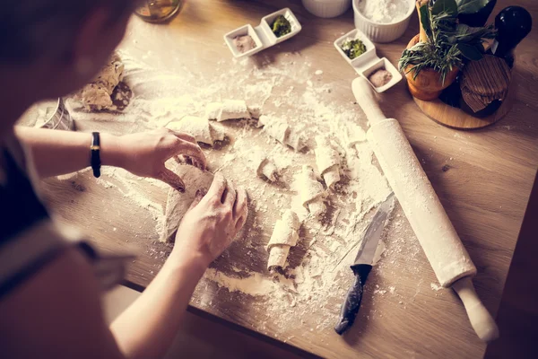 Woman cooking healthy balanced food.Carbohydrates.Whole grains.Dieting Concept.Healthy Lifestyle.Cooking food at home.Woman preparing dough for homemade puffed pastry on wooden table in the kitchen