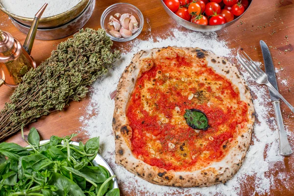 Traditional italian pizza with tomato sauce, garlic and basil, o
