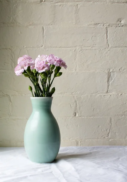 Pink carnations in green vase