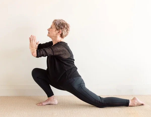 Older woman in yoga lunge