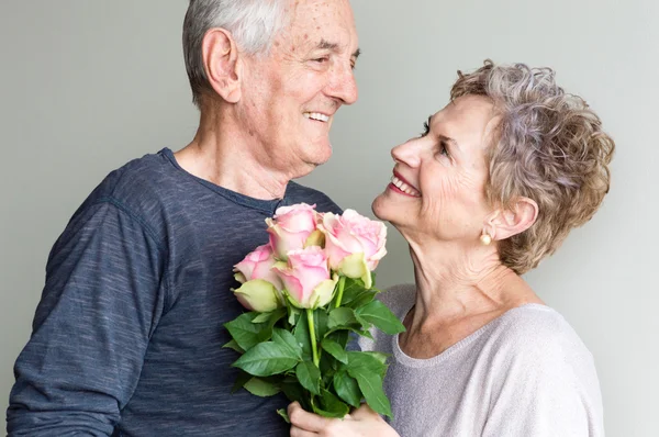 Older couple and pink roses