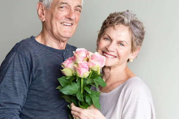 Older couple and pink roses