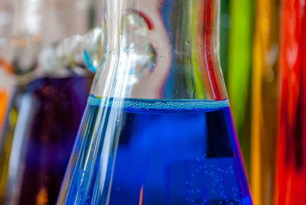 Chemistry blue feeling through blue chemical in a glass flask