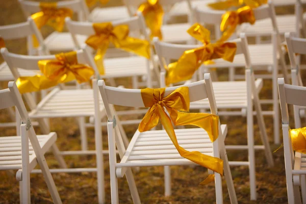 The decorations on the chairs at the wedding