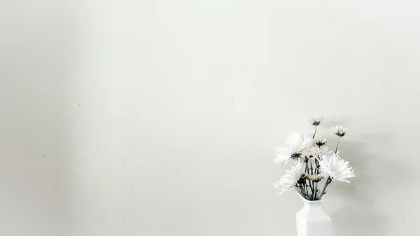 Some minimal flowers in the vase on white background.
