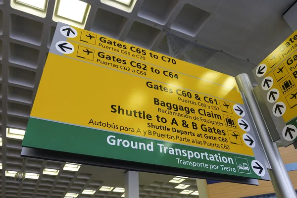 Direction signs at gate of JFK Airport New York  - NEW YORK, USA - APRIL 9, 2016