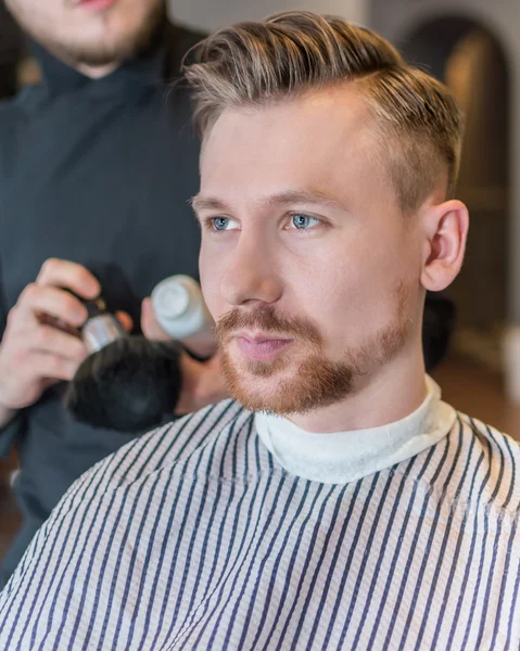 Portrait of a handsome man in barbershop