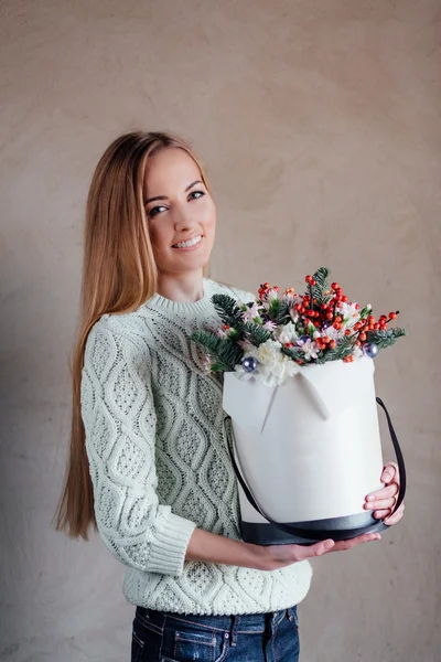 Girl holding hat box flowers