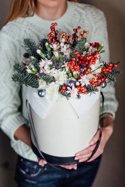 Girl holding hat box flowers