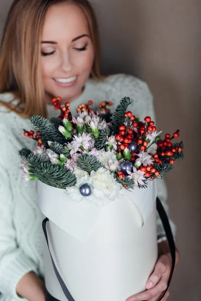 Girl holding hat box flowers