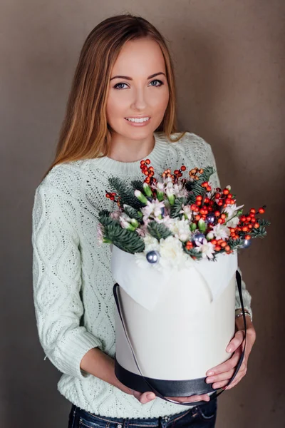 Girl holding hat box flowers
