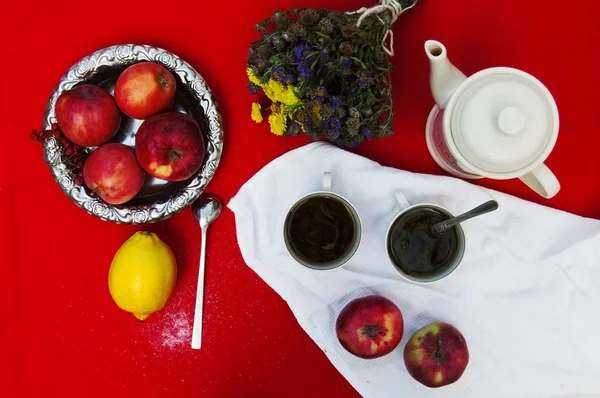 A cup of tea, yellow lemon, on a red background, food and drink,