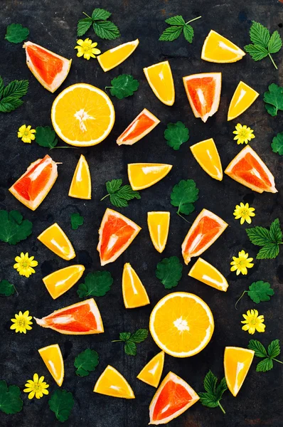 Mixed festive colorful tropical and citrus fruit sliced over bla